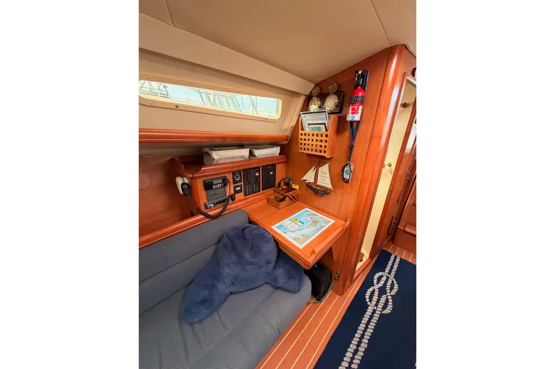 Slide: The Image of Interior of 2009 Hunter 33 sailboat with navigation station and cozy seating area. - 47