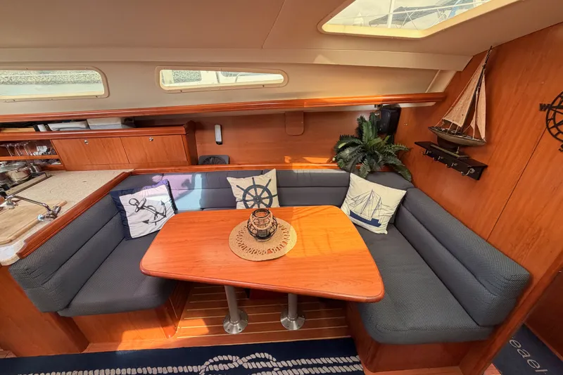Slide: The Image of Cozy interior of 2009 Hunter 33 sailboat with cushioned seating and nautical decor. - 50