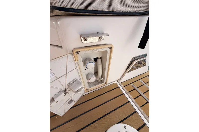 Slide: The Image of 2009 Hunter 33 boat deck with open utility compartment and controls. - 26