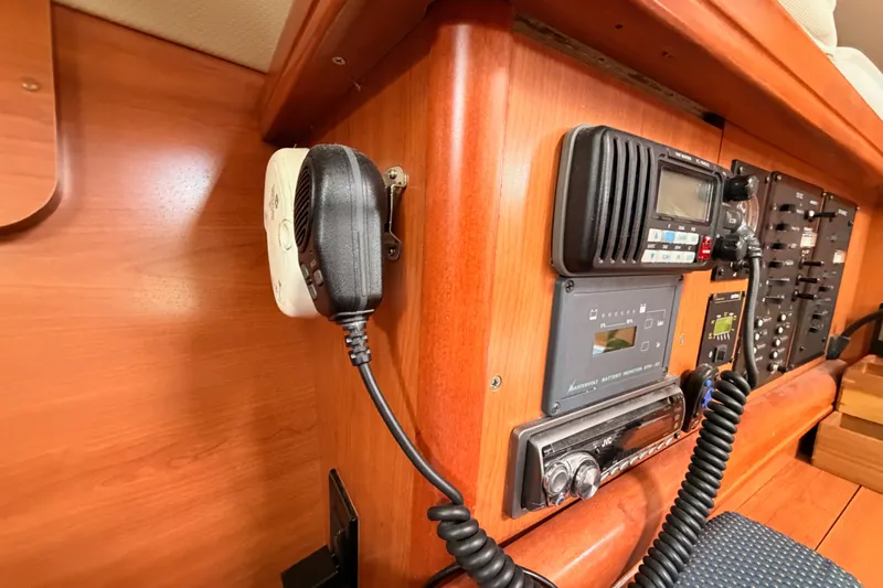 Slide: The Image of Interior of a 2009 Hunter 33 sailboat featuring communication and control panels. - 48