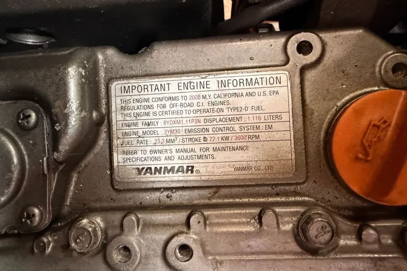 Slide: The Image of Engine information plate on a 2009 Hunter 33, featuring Yanmar specifications. - 64