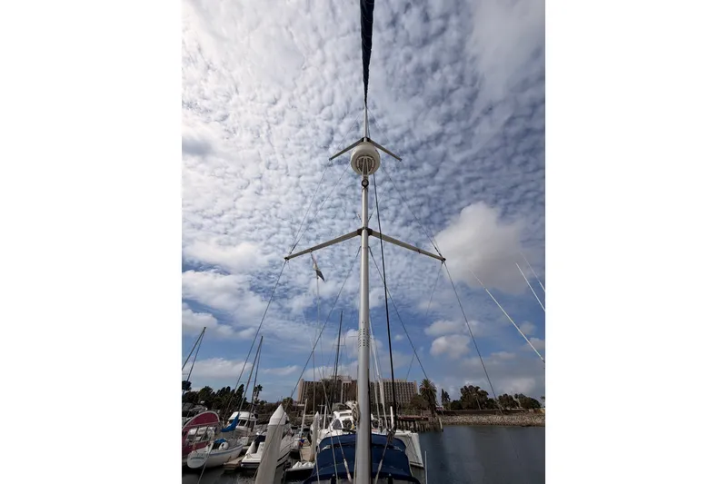 Slide: The Image of Sailboat mast of 2009 Hunter 33 under a cloudy sky at marina. - 18