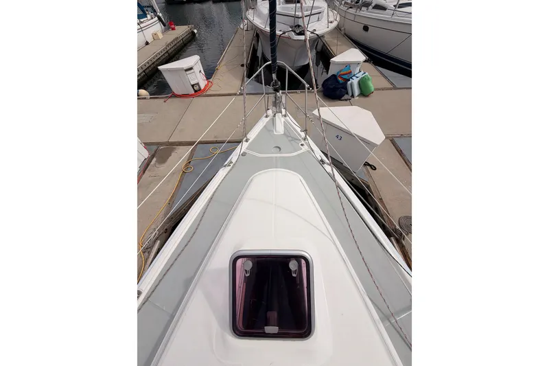 Slide: The Image of 2009 Hunter 33 sailboat docked, showing deck and hatch, marina setting. - 14