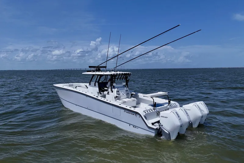 Slide: The Image of 2024 Freeman 38 boat with triple Mercury engines on open water under blue sky. - 10
