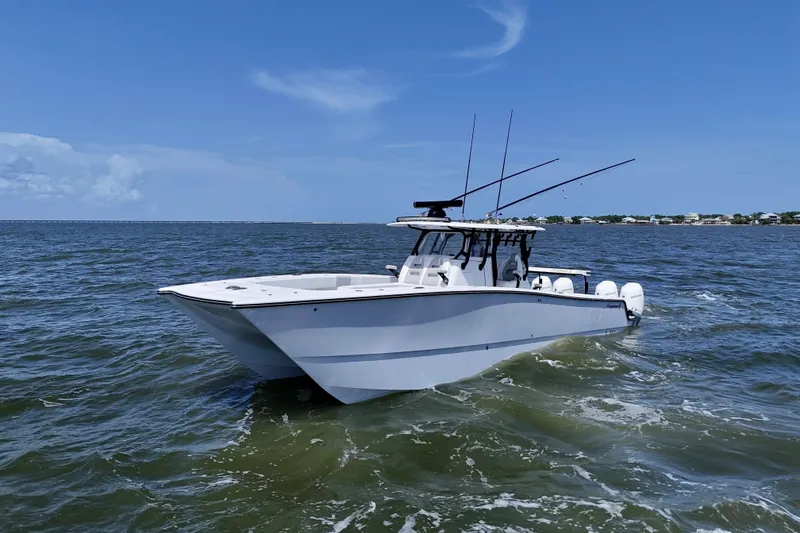 Slide: The Image of 2024 Freeman 38 boat cruising on open water under clear blue sky. - 8