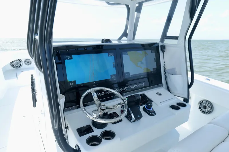Slide: The Image of 2024 Freeman 38 boat cockpit with advanced navigation displays and steering wheel. - 12