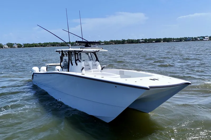 Slide: The Image of 2024 Freeman 38 boat on water, clear sky, coastal background. - 5