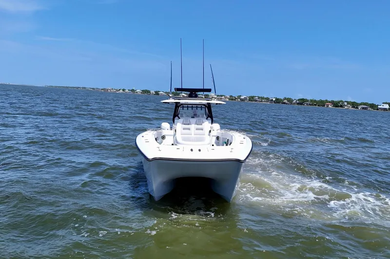 Slide: The Image of 2024 Freeman 38 boat cruising on open water under clear blue sky. - 7