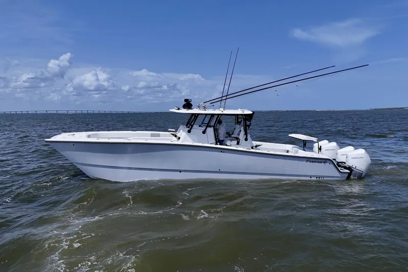 Slide: The Image of 2024 Freeman 38 boat cruising on open water under a clear blue sky. - 9