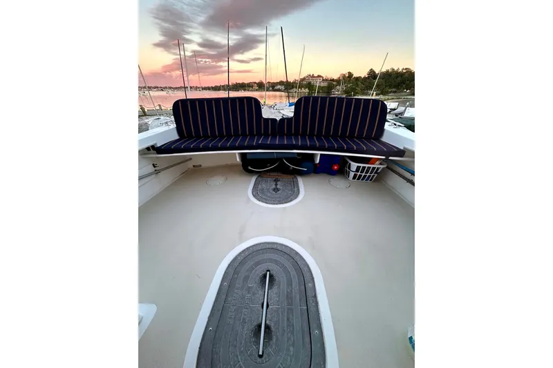 Slide: The Image of 2007 Eastern 31 Casco Bay boat interior with striped seating at sunset. - 15