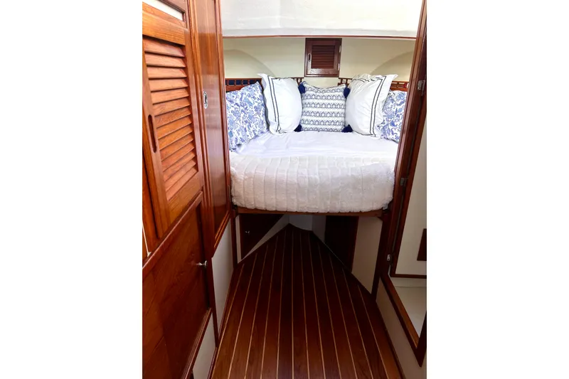 Slide: The Image of Cozy cabin interior of 2007 Eastern 31 Casco Bay boat with elegant bedding. - 13