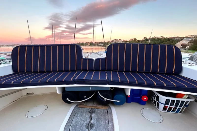 Slide: The Image of 2007 Eastern 31 Casco Bay boat with striped seating at sunset in a marina. - 16