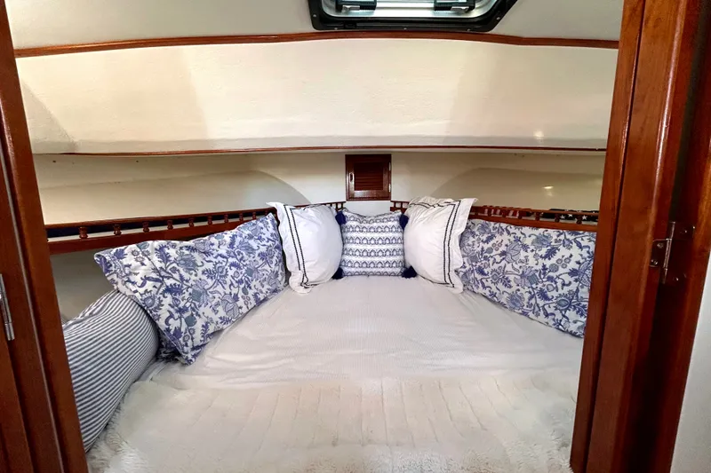 Slide: The Image of Cozy cabin interior of 2007 Eastern 31 Casco Bay with floral pillows and wooden accents. - 14