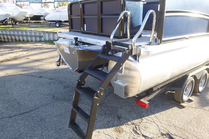 Slide: The Image of 2027 Premier 210 Sunsation Angler 4PT - CL boat with rear ladder and trailer. - 5