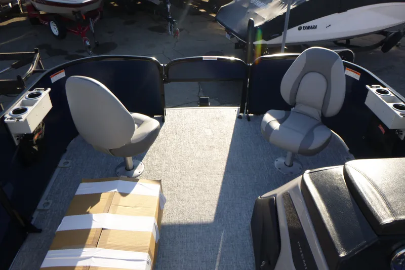 Slide: The Image of 2027 Premier 210 Sunsation Angler 4PT boat interior with seating and packaged box. - 15