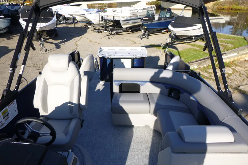 Slide: The Image of 2027 Premier 210 Sunsation Angler 4PT - CL boat interior with seating and steering wheel. - 18