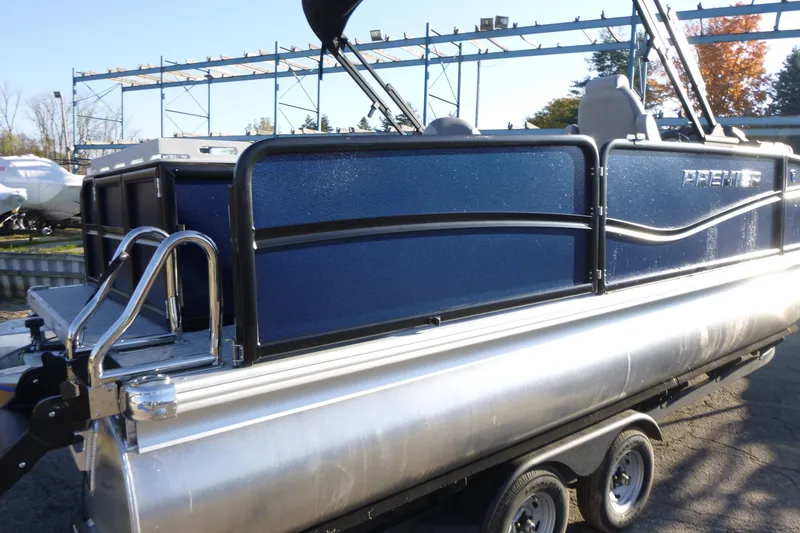 Slide: The Image of 2027 Premier 210 Sunsation Angler 4PT - CL pontoon boat on trailer, side view. - 3