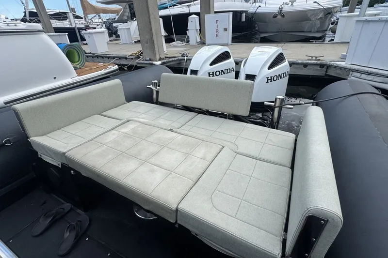 Slide: The Image of Seawater PHANTOM 280 boat with Honda engines, featuring a convertible seating area, docked at a marina. - 16