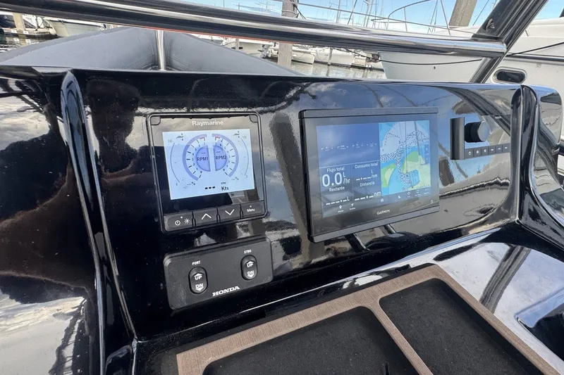 Slide: The Image of Control panel of 2023 Seawater PHANTOM 280 boat with Raymarine and Garmin displays. - 18
