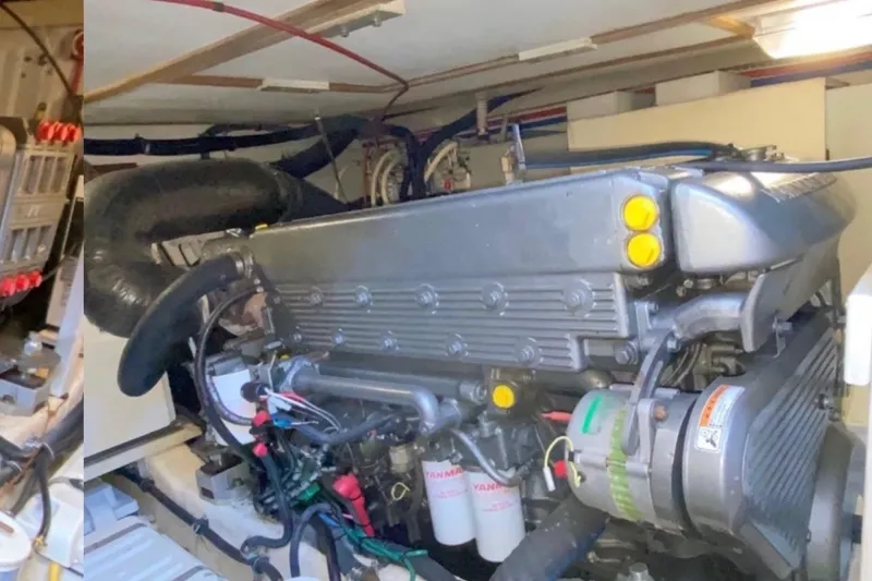 Slide: The Image of Engine room of a 2004 Sabre 42 Fly Bridge boat, showcasing detailed machinery. - 16