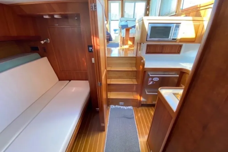Slide: The Image of Interior of 2004 Sabre 42 Fly Bridge yacht with seating and kitchenette. - 13