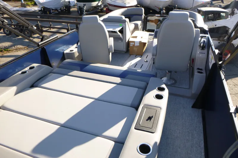 Slide: The Image of 2027 Premier 210 Sunsation RL - CL pontoon boat interior with seating and cup holders. - 22