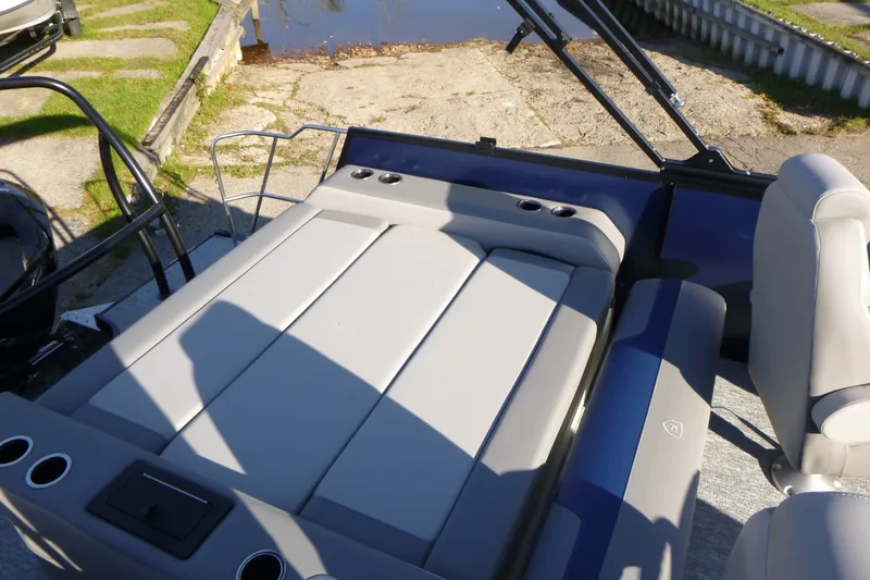 Slide: The Image of 2027 Premier 210 Sunsation RL-CL boat interior with cushioned seating and cup holders. - 20