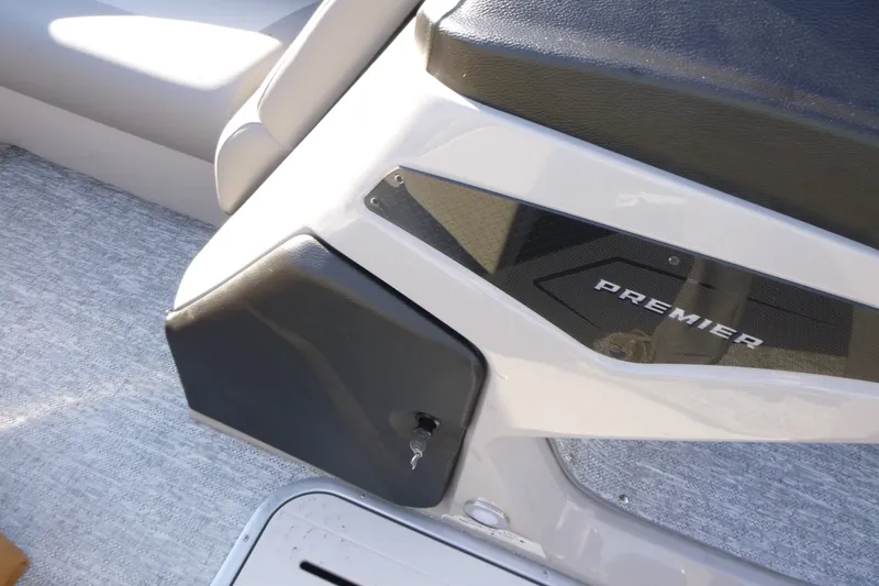 Slide: The Image of Premier 210 Sunsation RL - CL 2027 boat interior detail with logo and seating. - 26