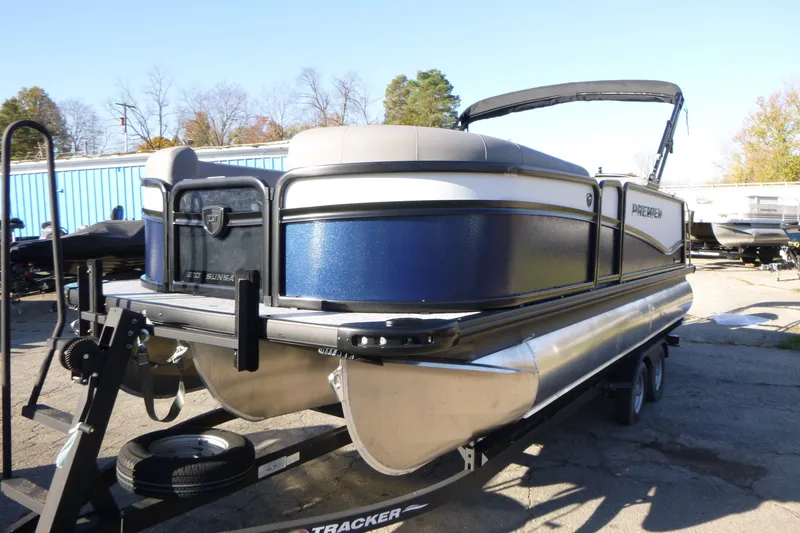 The Image of 2027 Premier 210 Sunsation RL - CL pontoon boat on trailer, outdoor setting. - 0