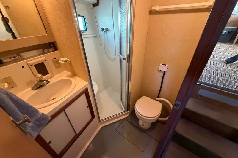 Slide: The Image of Bathroom interior of 1983 Bertram 38III Convertible yacht with sink, shower, and toilet. - 19