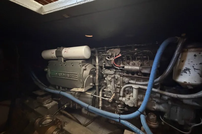Slide: The Image of Engine compartment of a 1983 Bertram 38III Convertible boat, featuring Yanmar components. - 26