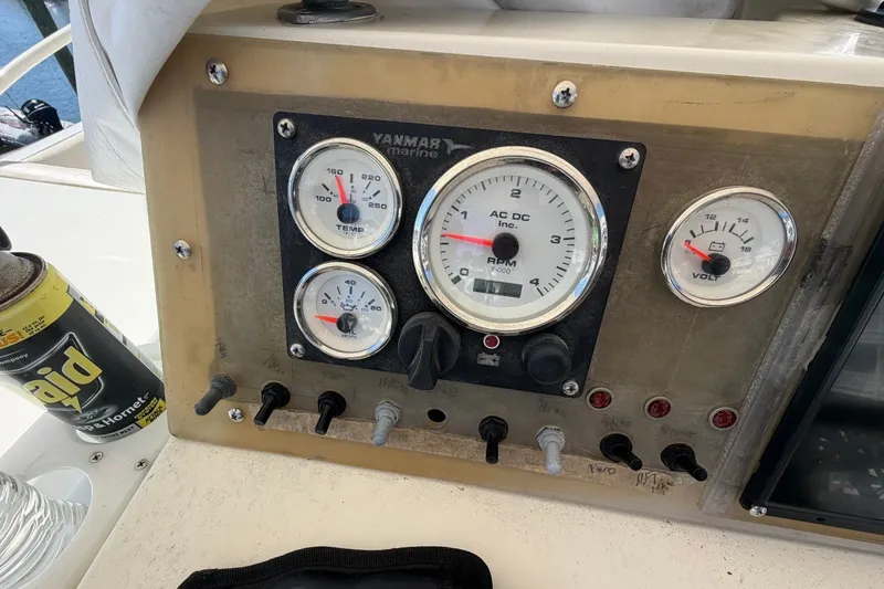 Slide: The Image of Instrument panel of a 1983 Bertram 38III Convertible boat with gauges and switches. - 38