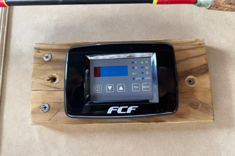 Slide: The Image of An FCF air conditioning control panel is mounted on a wooden board. - 28