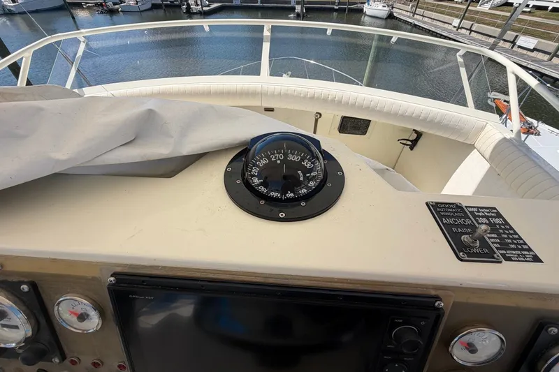 Slide: The Image of Cockpit view of a 1983 Bertram 38III Convertible boat with compass and controls. - 34
