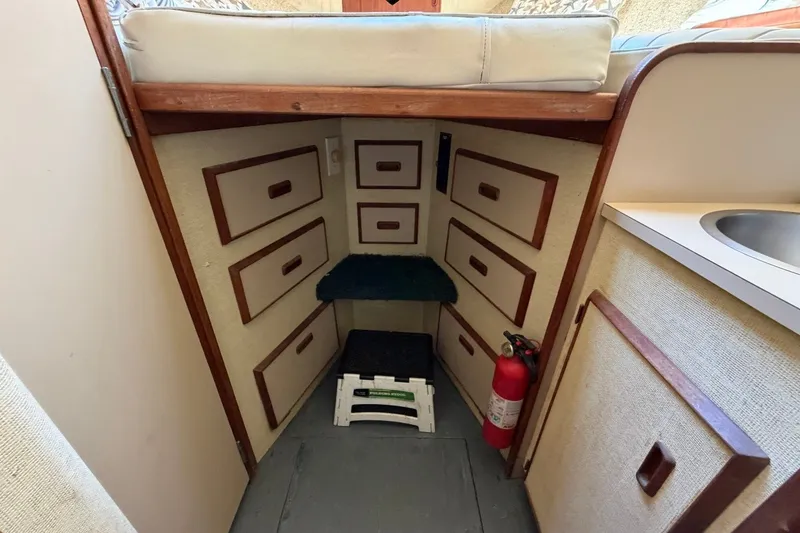 Slide: The Image of Interior of 1983 Bertram 38III Convertible with storage drawers and fire extinguisher. - 16