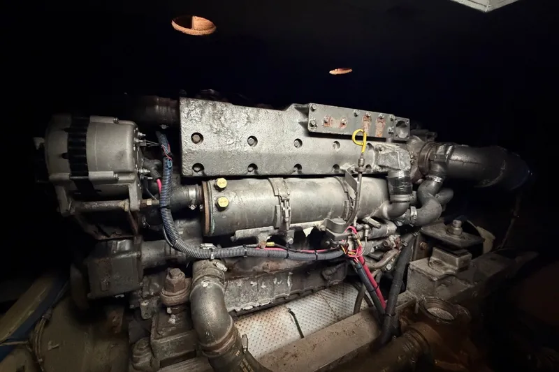 Slide: The Image of Engine of a 1983 Bertram 38III Convertible boat, showcasing mechanical components. - 25