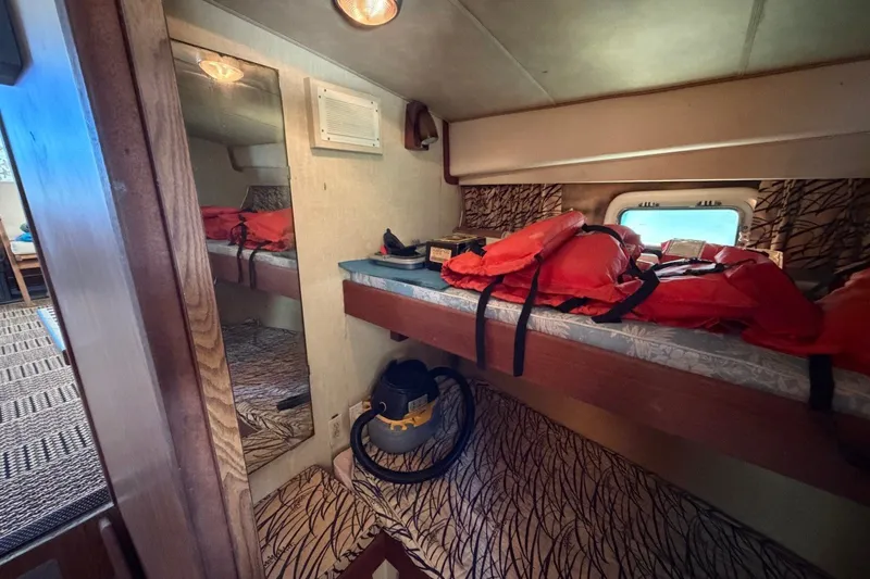 Slide: The Image of Interior of 1983 Bertram 38III Convertible with bunk beds and life jackets. - 22