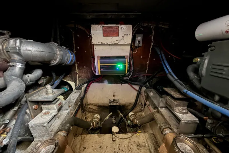 Slide: The Image of Engine room of a 1983 Bertram 38III Convertible boat, showcasing mechanical components. - 24