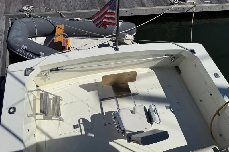 Slide: The Image of 1983 Bertram 38III Convertible boat deck with fishing chair and American flag. - 43