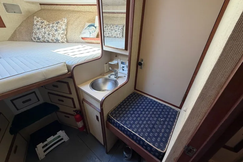 Slide: The Image of Cozy cabin interior of 1983 Bertram 38III Convertible with bed, sink, and storage. - 17