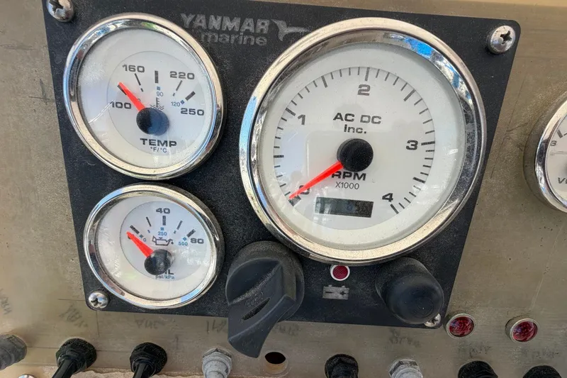 Slide: The Image of Instrument panel of a 1983 Bertram 38III Convertible boat with gauges and controls. - 39
