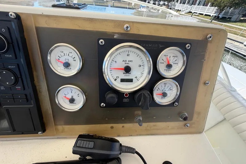 Slide: The Image of Dashboard of a 1983 Bertram 38III Convertible boat with gauges and controls. - 37