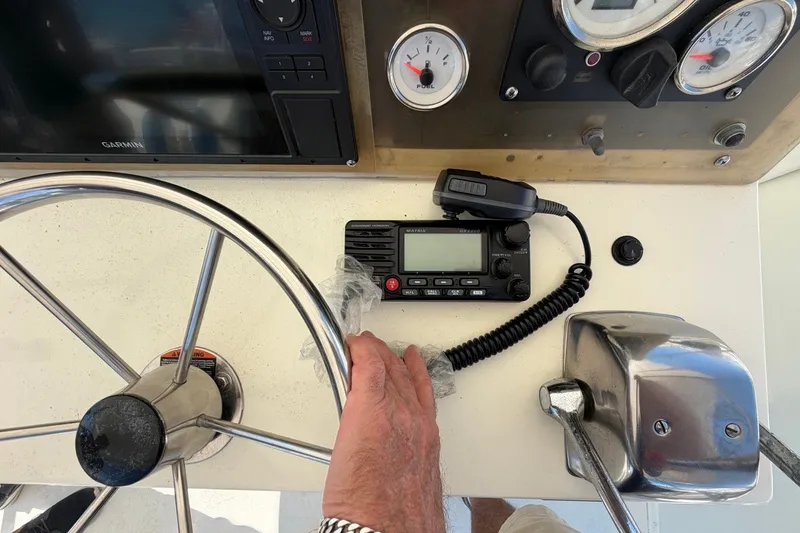 Slide: The Image of Boat helm of 1983 Bertram 38III Convertible with steering wheel, radio, and gauges. - 36