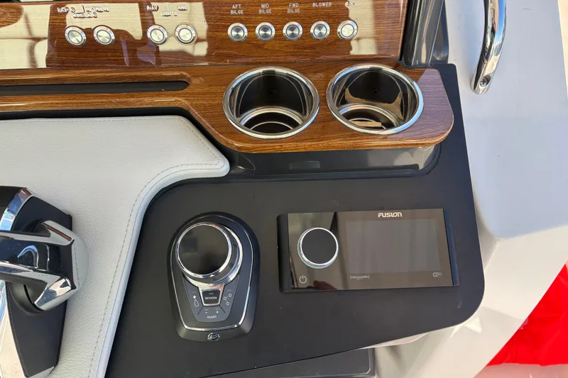 Slide: The Image of Dashboard of 2026 Tiara Yachts 34 LS featuring controls and cup holders. - 31