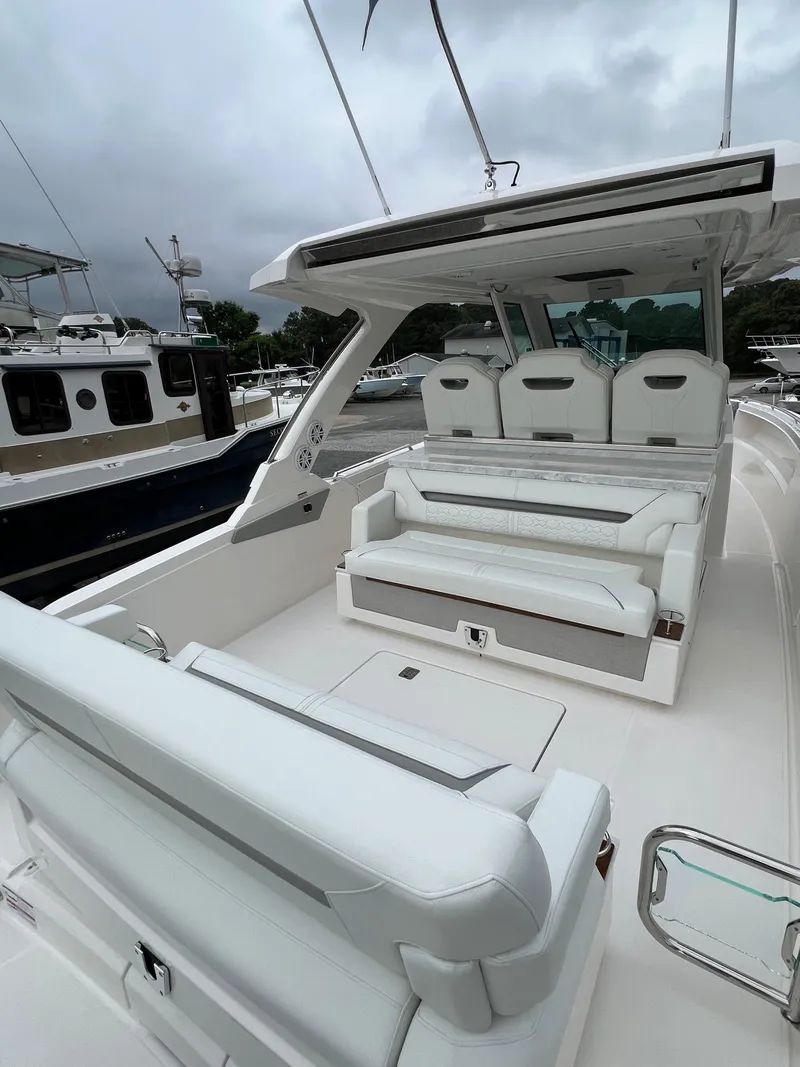 Slide: The Image of 2026 Tiara Yachts 34 LS luxury boat interior with white seating and sleek design. - 18