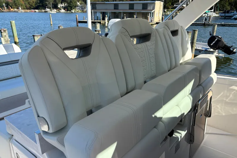 Slide: The Image of Luxury seating on 2026 Tiara Yachts 34 LS, docked by serene waterfront. - 23