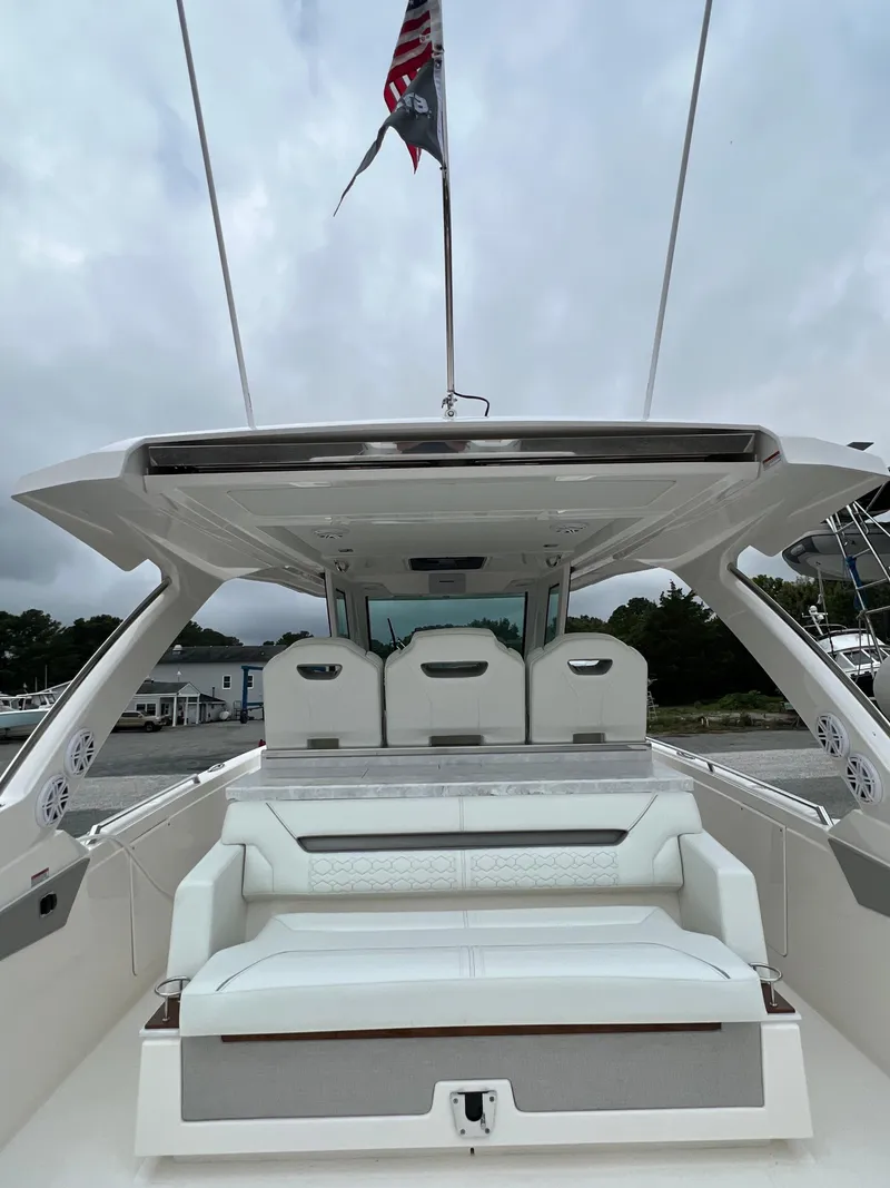 Slide: The Image of 2026 Tiara Yachts 34 LS luxury boat interior with seating and canopy. - 16