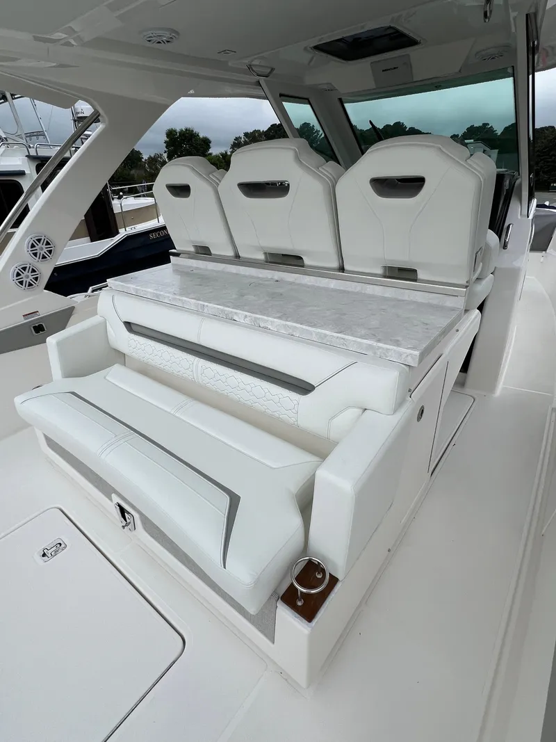 Slide: The Image of 2026 Tiara Yachts 34 LS interior with luxurious white seating and sleek design. - 17