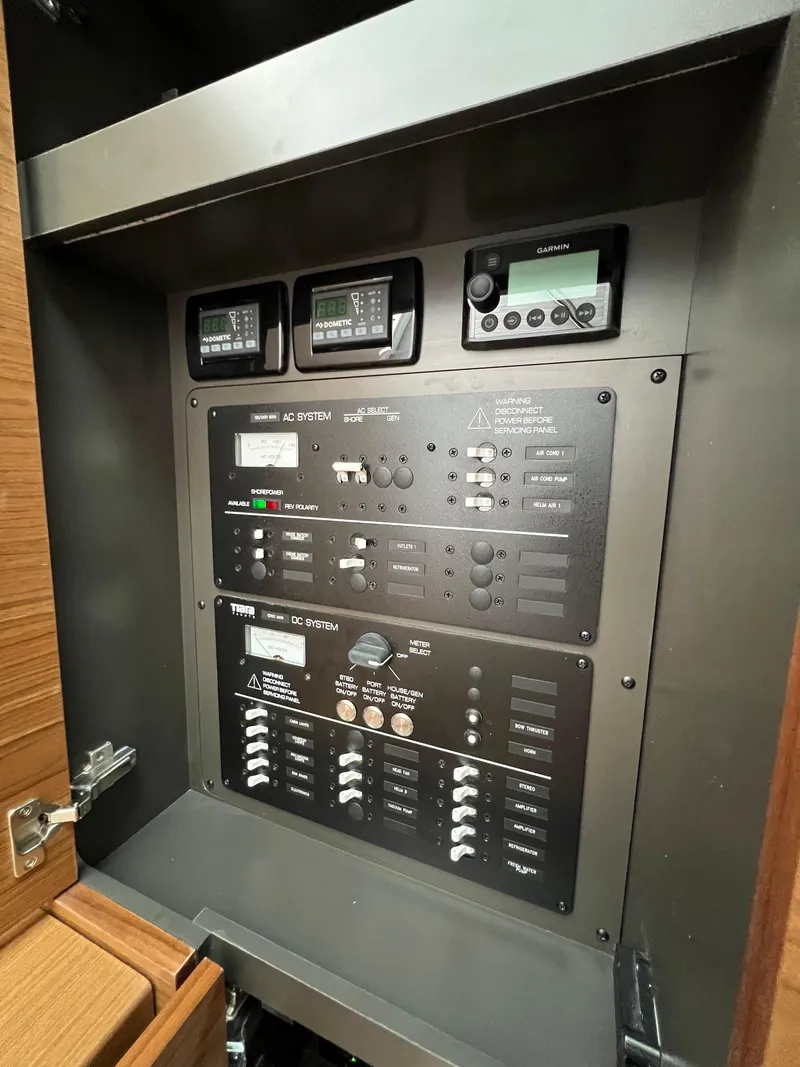 Slide: The Image of Electrical control panel inside 2026 Tiara Yachts 34 LS, featuring AC and DC systems. - 13