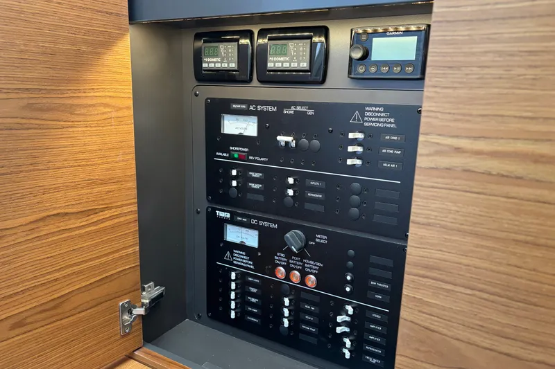 Slide: The Image of Electrical control panel on 2026 Tiara Yachts 34 LS, featuring AC and DC systems. - 34
